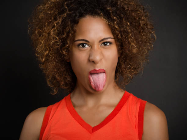 istock Beautiful woman pulling her tongue out 1318010003
