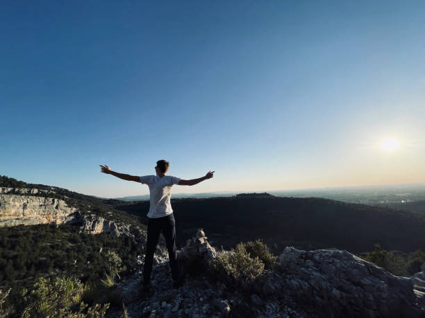 istock Hiker relaxes on sunny mountain ridge at sunrise 1318010293