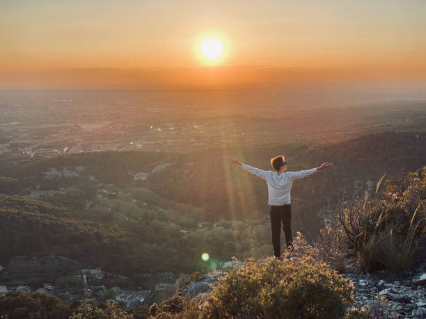 istock Hiker relaxes on sunny mountain ridge at sunrise 1318010331