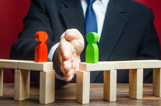 istock Man divides conflicting sides parties with a hand. Avoidance violence, bullying. protection of witnesses. Mediator services. Stop fight, ceasefire clashes, hot phase of war. Finding a compromise. 1318011323
