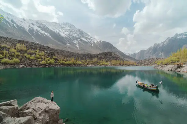 Young Caucasian woman looking at Upper Kachura lake in Gilgit-Baltistan