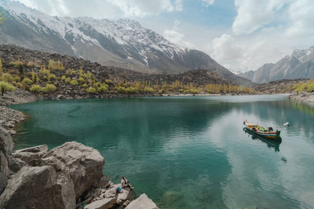 Young Caucasian woman looking at Upper Kachura lake in Gilgit-Baltistan