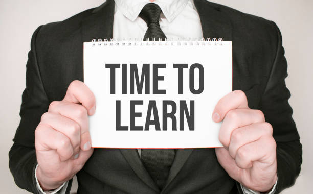 istock Businessman holding a notepad with text Time to Learn 1318013845