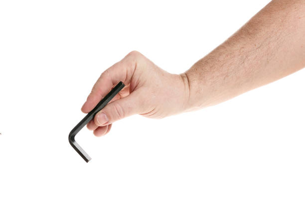 istock Hand holds a black hex key on a white background, a template for designers. Close up 1318013897