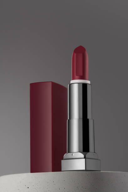 istock Open dark red lipstic on gray background and concrete podium 1318016849