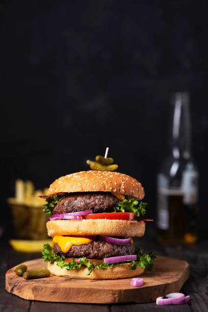 istock Home made burgers with two cutlets and beer on a table 1318016853