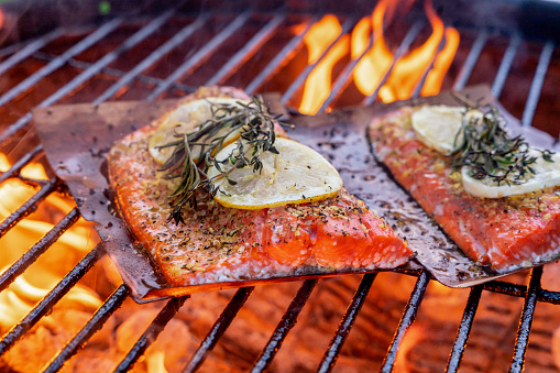 Wild Caught Sockeye Salmon Fillets On A Hot Charcoal Grill With Flames, Close Up