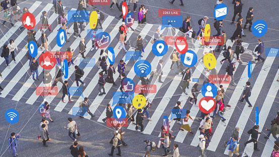 4k resolution Social Media Signs, Symbols and Emojis connect with crowded people across intersection, futuristic technology design with people lifestyle