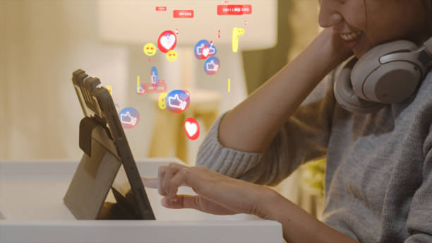 istock Asian woman using tablet with animation social media icon 1318018797