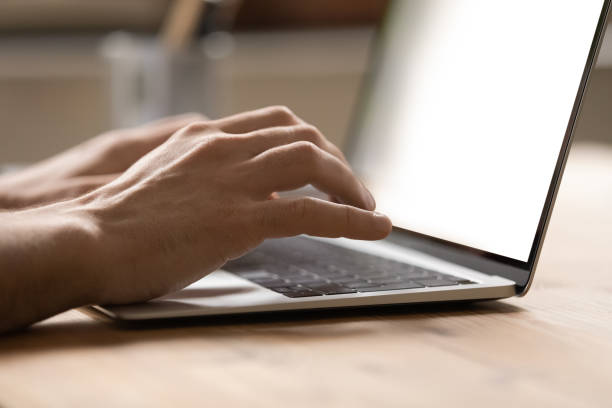 istock Close up businessman using laptop, typing on keyboard, writing message 1318021890