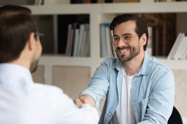 istock Hr manager shaking smiling man hand, congratulating successful candidate 1318021898