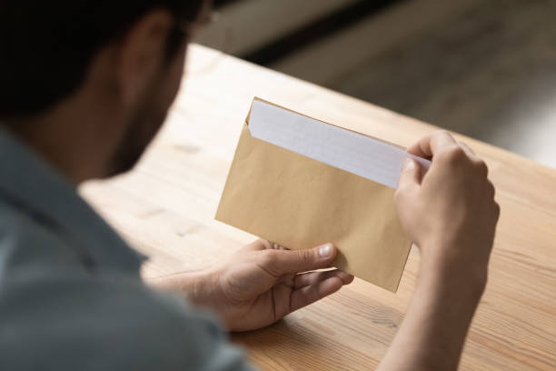 istock Close up businessman opening envelope with letter, working with correspondence 1318021900