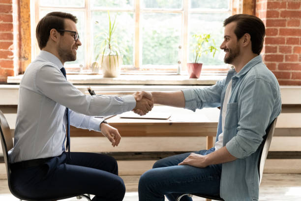 istock Side view happy businessmen shaking hands, closing successful deal 1318021936