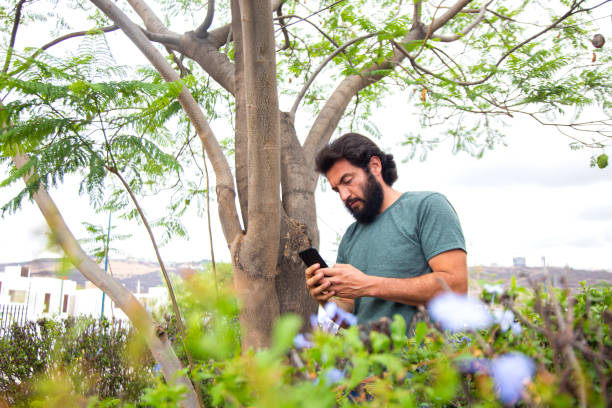 istock Man working in gardening, looking at his cell phone 1318022016