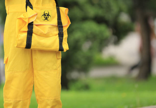 virus disinfectant man in yellow protective suit virus disinfectant man in yellow protective suit biohazard cleanup stock pictures, royalty-free photos & images