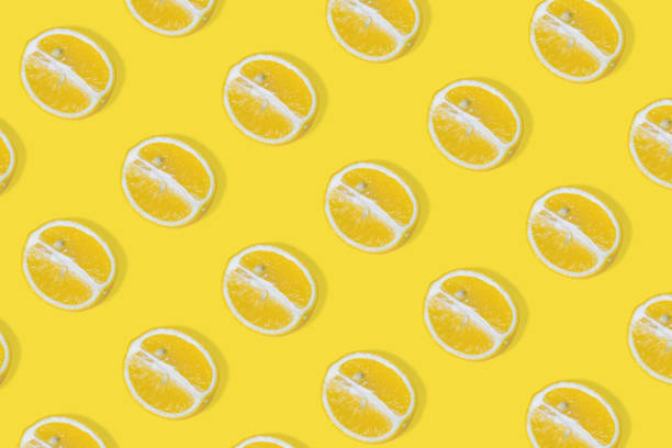 istock Trendy summer pattern with yellow lemon slice on illuminating yellow background. 1318025974