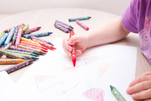 istock child draws in red colored chalk on paper 1318027047