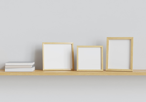Three photo mockup frames and books on the shelf. Clipping path included. 3D render. 3D illustration.