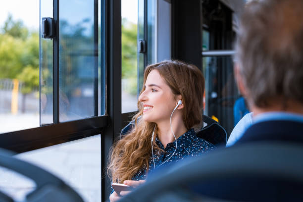 istock Smiling young female traveling in bus 1318029186