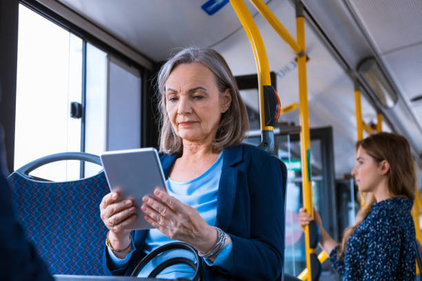 istock Senior businesswoman using digital tablet in bus 1318029319