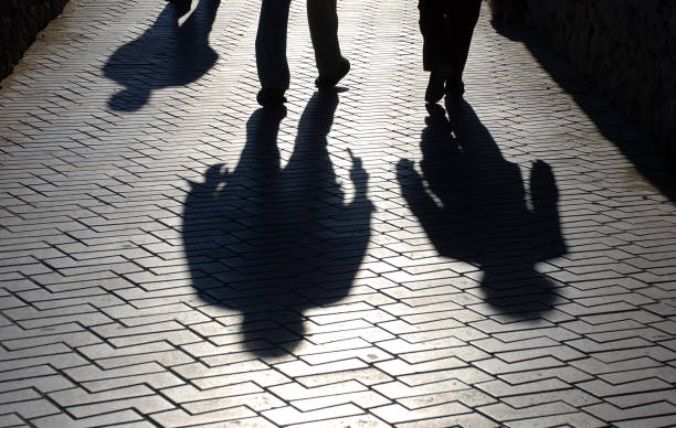 istock Black shadows of people walking 1318030925