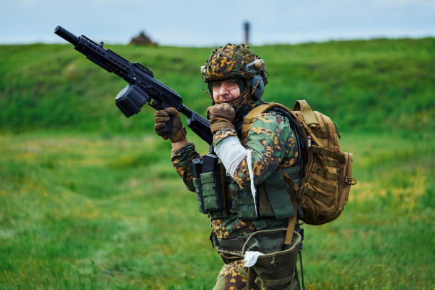 istock A soldier  with a bandaged hand holds a weapon in his hand 1318031935