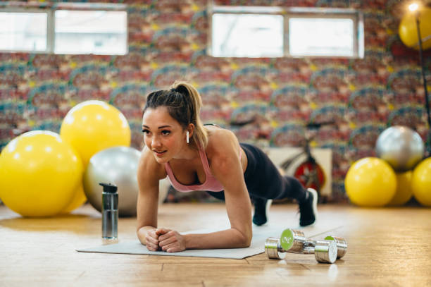 istock Woman in a plank pose in a gym 1318032107