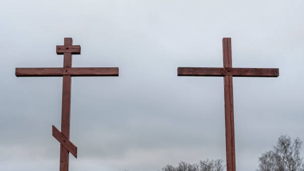 istock Orthodox and Catholic crosses side by side on dramatic sky background. The concept of unity of faith. Space for text. 1318033417