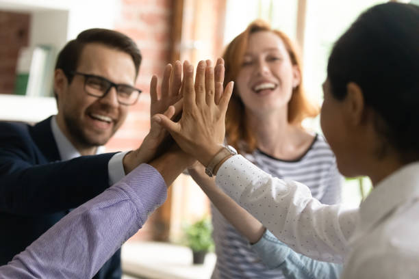 istock Close up diverse employees team giving high five, celebrating success 1318034185