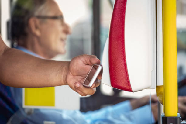 istock Male passenger paying fare through smart phone in bus 1318034430