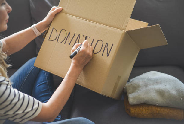 istock woman puts donations in a box 1318036920