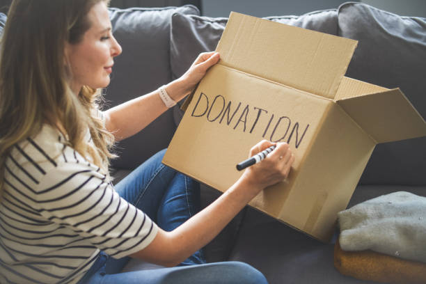 istock woman puts donations in a box 1318037665
