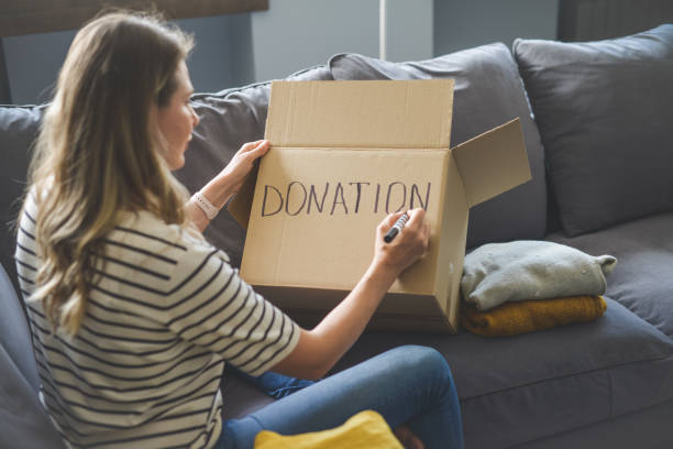 istock woman puts donations in a box 1318037926