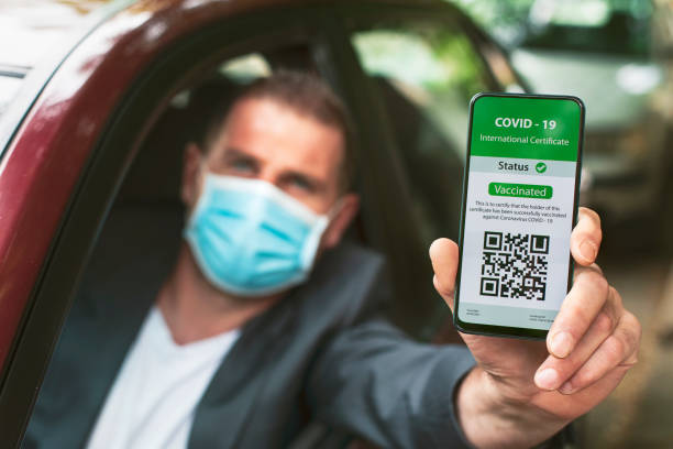 istock Driver showing digital certificate of Covid-19 vaccination 1318045208