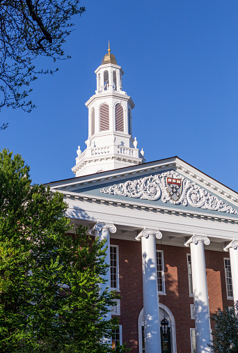 Boston, Massachusetts, USA - May 13, 2021: Close up of the Baker Library on the Harvard Business School (HBS) campus. Dedicated in 1927 and named for George F. Baker, the benefactor who funded HBS's original campus. It is the largest business library in the world.