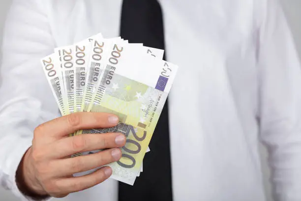 Businessman holding 200 euro. economy and money concept.