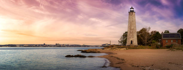 Panoramic view on a lighthouse on the Atlantic Ocean Coast. Panoramic view on a lighthouse on the Atlantic Ocean Coast. Colorful Sunrise Sky Art Render. Taken in Lighthouse Point Park, New Haven, Connecticut, United States. connecticut stock pictures, royalty-free photos & images
