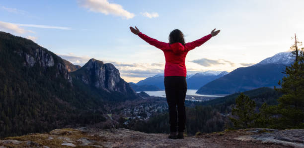 istock Adventurous Woman Hiking in the mountains during a Spring Sunset 1318052559