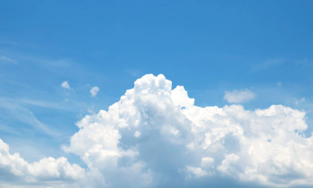 istock white fluffy clouds in the blue sky 1318052677