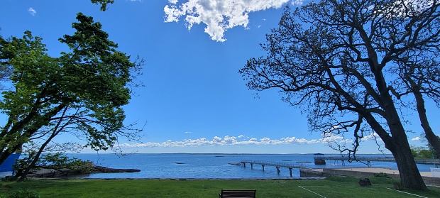 Lake view with grass and blue sky in Mamaroneck