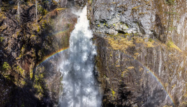 istock Waterfall rushing down a rocky canyon in the Canadian Mountains. 1318053546