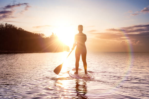 istock Adventurous girl on a paddle board is paddeling in the Pacific West Coast Ocean 1318053662