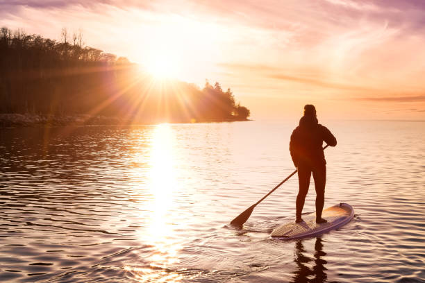 istock Adventurous girl on a paddle board is paddeling in the Pacific West Coast Ocean 1318053667