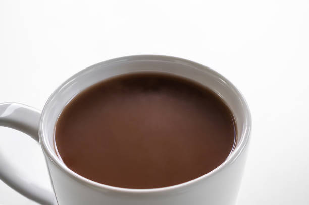 istock Chocolate milk close up in white cup on white background. 1318054688