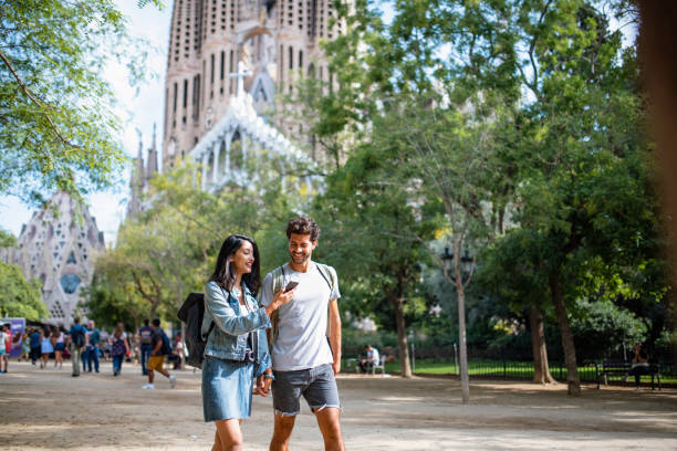 istock Relaxed Young Tourists Walking in Barcelona Public Park 1318055593