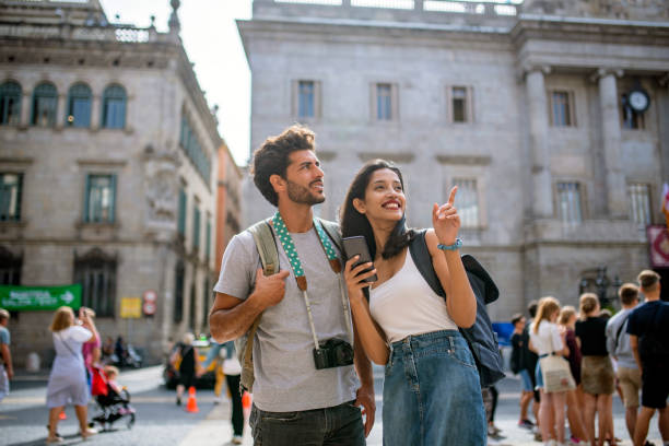 istock Young Tourists with Smart Phone Looking at View in Barcelona 1318055612
