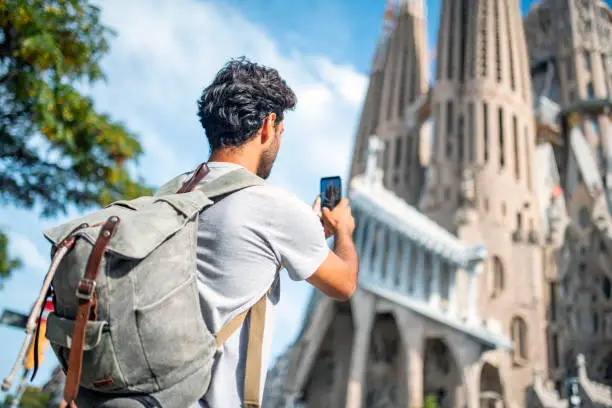 Photo of Backpacker Photographing Sagrada Familia with Smart Phone