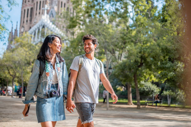 istock Vacationing Couple Walking Through Barcelona Public Park 1318055644