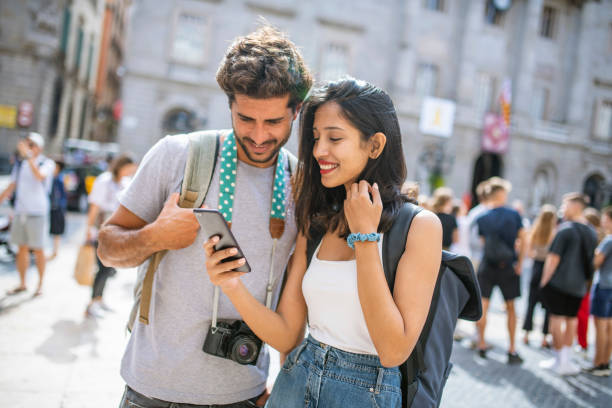 istock Vacationers Checking Photos on Smart Phone in Barcelona 1318055656