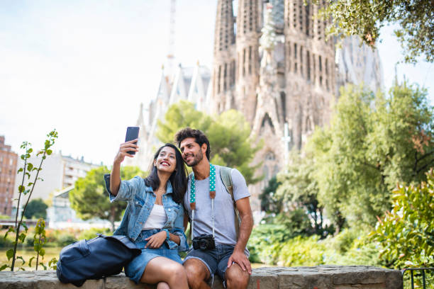 istock Young Couple Taking Break from Sightseeing for Selfie 1318055684